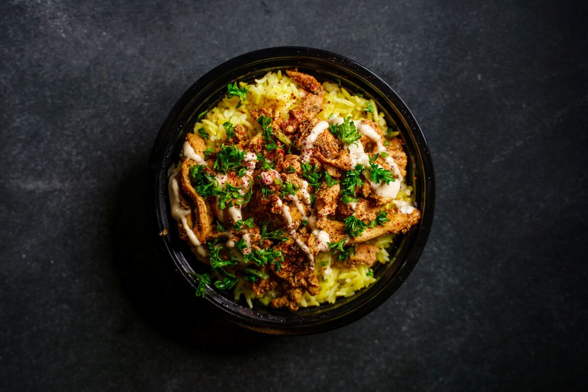 Chicken shawarma bowl with rice, parsley, and tahini